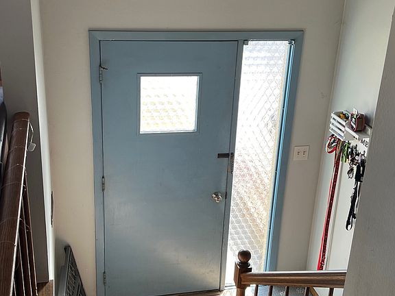 Front door opens up into classic split-level living situation.