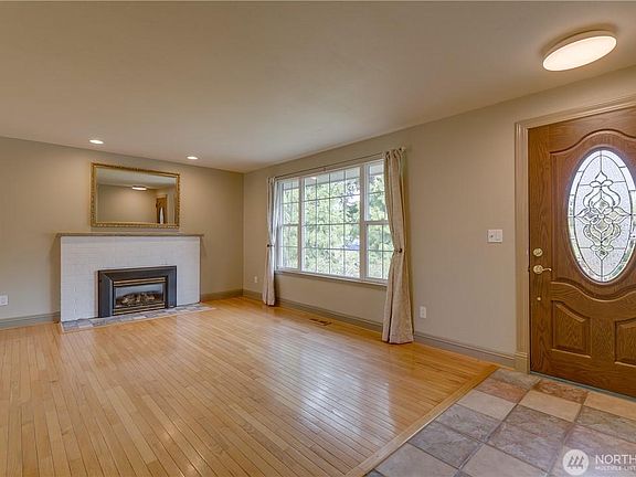 Light and bright upstairs living room with gas fireplace.