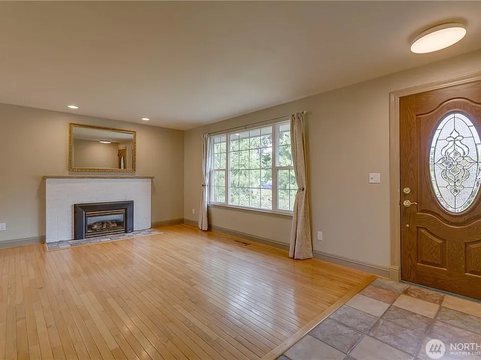 Light and bright upstairs living room with gas fireplace.