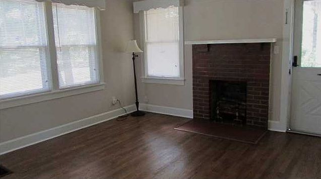Pretty hardwood floors and fireplace in living room