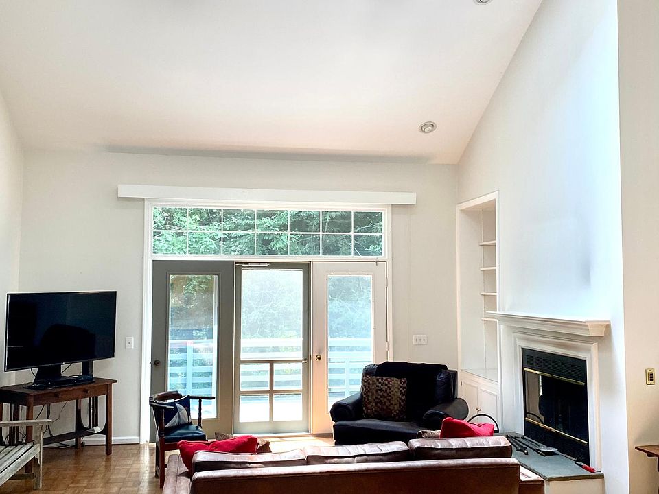 Living room with fireplace. Double height and open to 28 ft by 11 ft deck with electric awning.