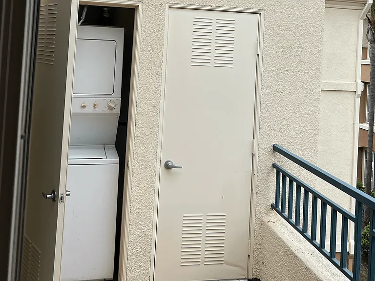 In-unit washer/dryer off balcony at Carmel Heights Apartments in San Diego, California.