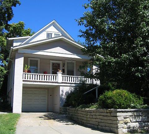 Sunny South side with driveway, garage and porch