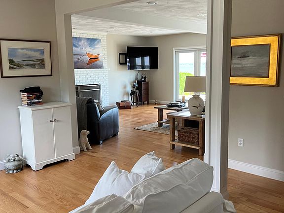 View from the front door entry across the sitting area into the main living room. Laundry room is just off to the left, out of view. Main Bathroom is just off to the right. Plenty of recessed lighting and lamp lighting.