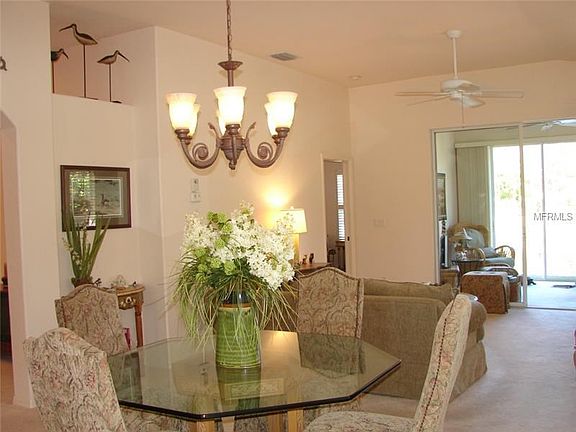 Spacious dining room and living room open to the sunroom.