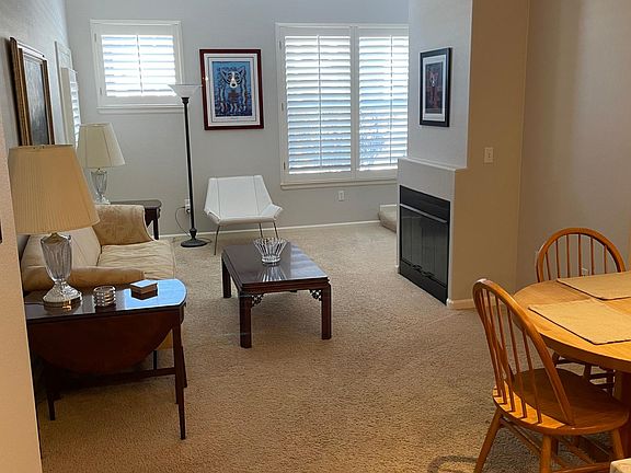 Downstairs living space with fireplace and part of the dining space.