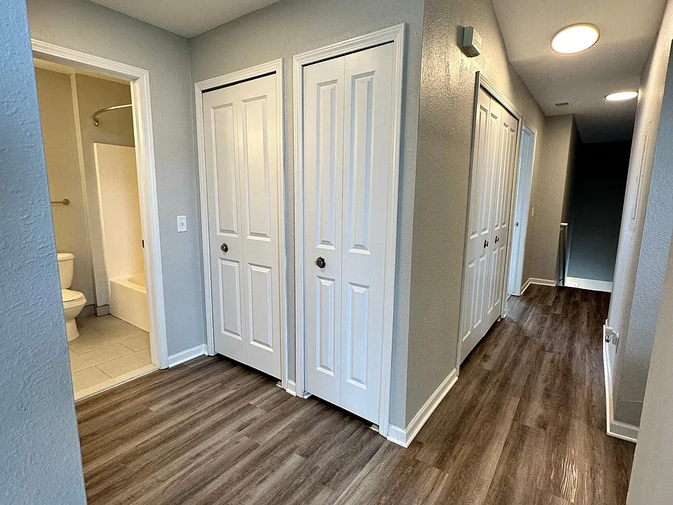 Guest bathroom entrance, linen closet, water heater closet.