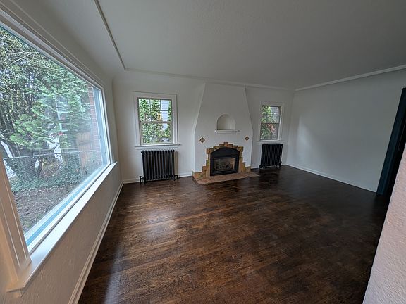Living room with fireplace and picture window.