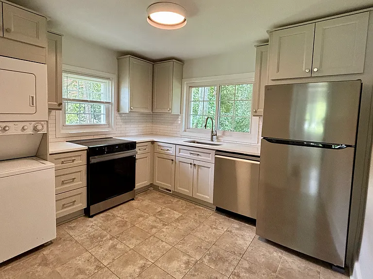 Fully renovated kitchen. Quartz countertops, tiled backsplash, brand new cabinetry.