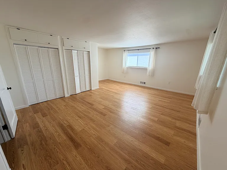 Master bedroom with brand new floors, paint, and closet doors