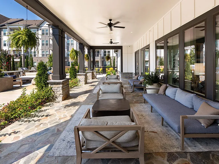 Covered Patio Featuring Outdoor Sofas and Stone Tile Flooring