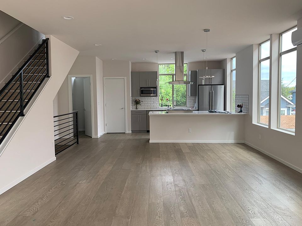 Wide open concept dining and living area. Kitchen boasts stainless steel appliances and a pantry.