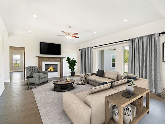 Spacious great room with fireplace, virtually staged for demonstration