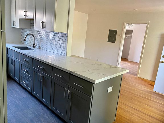 DEEP SINK DISHWASHER TO THE LEFT, PLENTY OF COUNTER SPACE WITH PENINSULA, SPACE FOR BAR CHAIRS AND OUTLET.