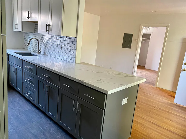 DEEP SINK DISHWASHER TO THE LEFT, PLENTY OF COUNTER SPACE WITH PENINSULA, SPACE FOR BAR CHAIRS AND OUTLET.