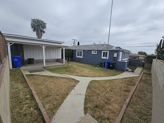 Enclosed back yard viewed from back gate.