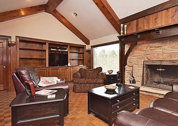 Great room with stone fireplace & built-in shelves.