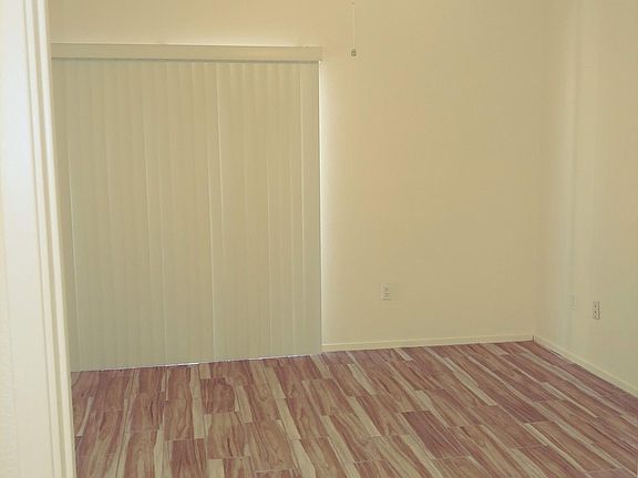 Master bedroom: ceiling fan, tile floors, and new blinds. Patio door leads to patio.