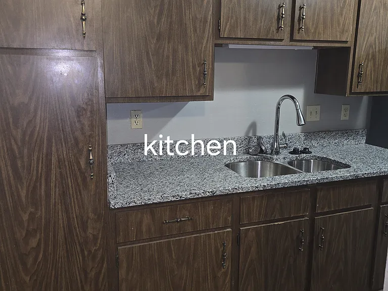 Pantry & cabinets, granite countertops, pull down faucet and double sink with disposal.