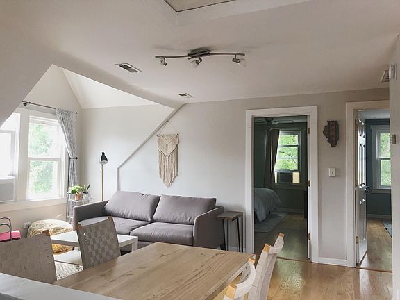 View into Living and Dining Space with entrance to two bedrooms