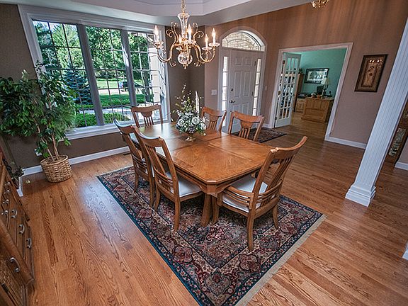 The dining room is graced by the beautiful tray ceiling, gold plated chandelier and transom window.