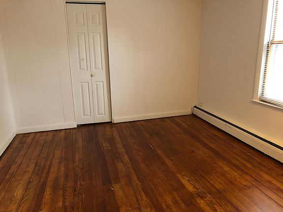 Main bedroom with newly refinished hardwood floor and access to walk-in closet in addition to the closet pictured here.