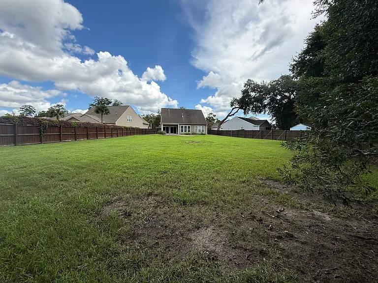 Unmatched privacy and space! This wide view highlights an expansive, flat green lawn that is absolutely perfect for outdoor activities, pets, or your dream garden setup."