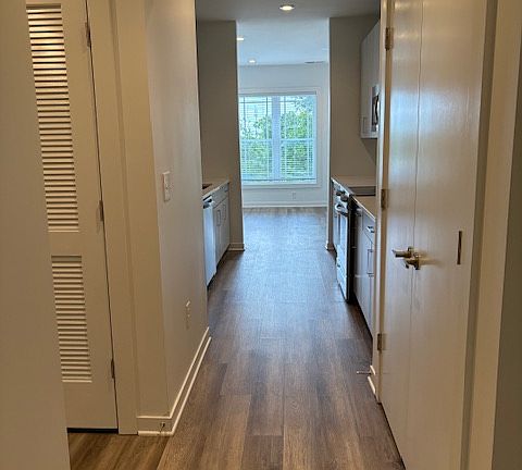 Welcome in! This is the view from the front door. To the right is the large pantry and to the left you can see the laundry closet. Straight ahead is the galley kitchen into the living area.