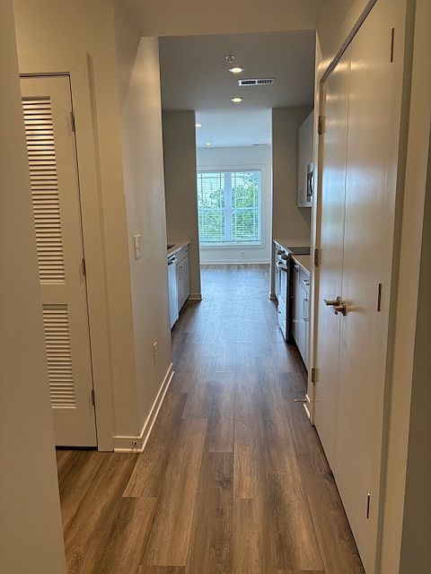 Welcome in! This is the view from the front door. To the right is the large pantry and to the left you can see the laundry closet. Straight ahead is the galley kitchen into the living area.