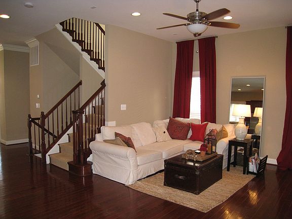 Open floor plan with turned stairs, recessed lights, cherry hardwood floors