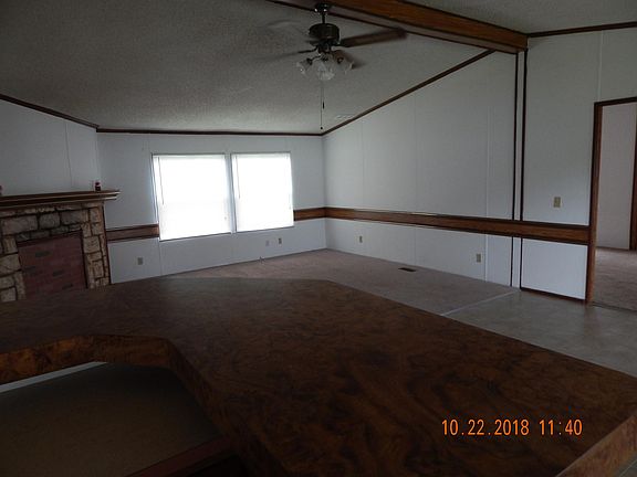 Looking at Living room from kitchen. Notice ceiling fan.