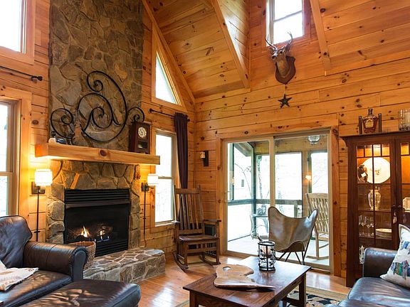 Great Room with gas fireplace, large skylight, pony up bar, opens to screened porch.