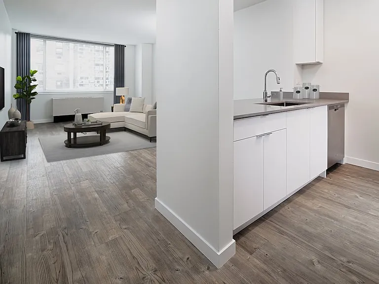 Renovated Package I kitchen, living, and dining with hard surface plank flooring