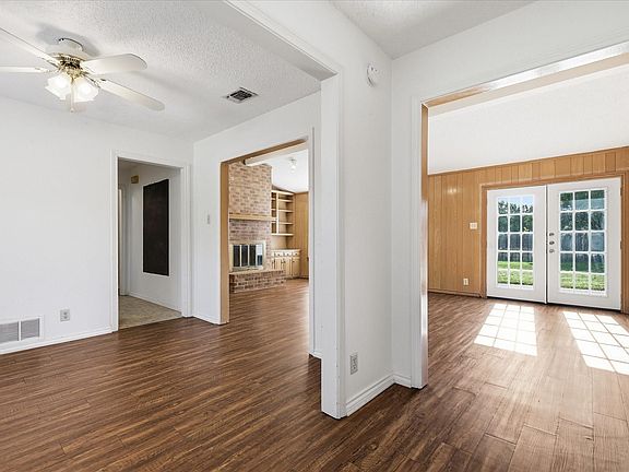 Clear views from the front entry through the dining room to the living room and back patio doors