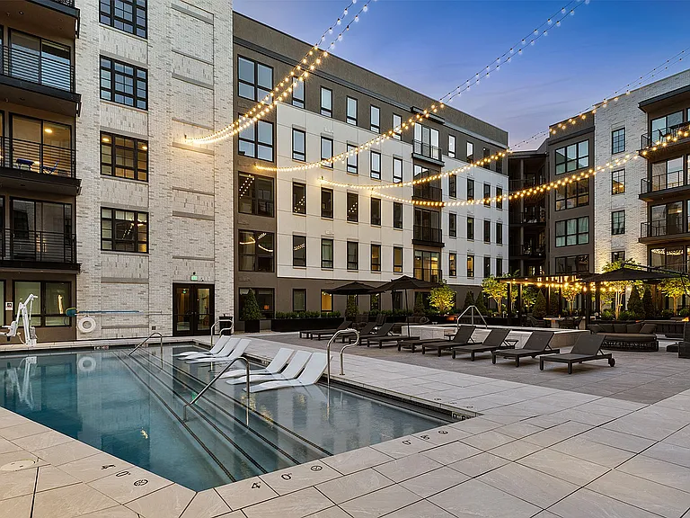 Side angle of rooftop deck with pool, spa, and lights