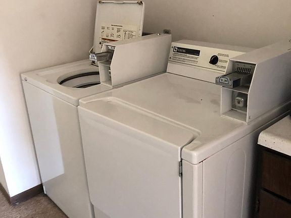 Coin operated washer and dryer are a few steps away in the hallway