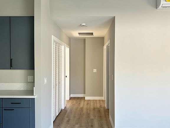 Vaulted ceilings and wide hallway leading to bedrooms