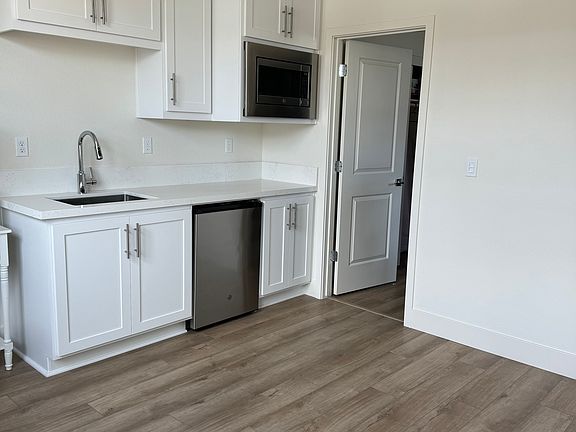 Kitchenette with a fridge and microwave oven.
