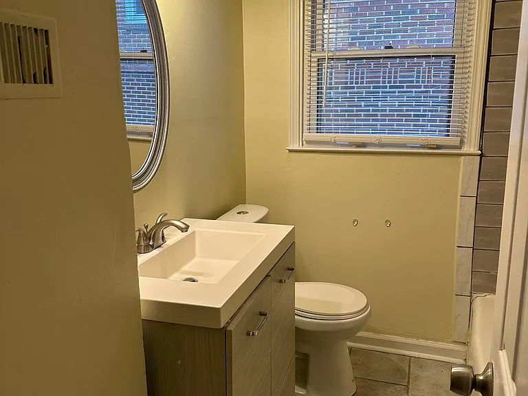 well ventilated bathroom with a linen closet