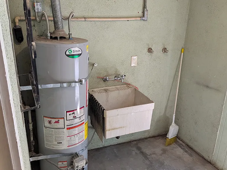 laundry room right off hallway with outside entrance