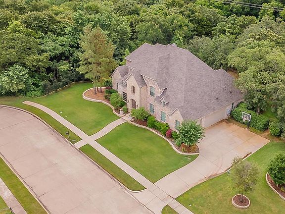 Professionally designed landscaping welcomes you as you drive up to this beauty!