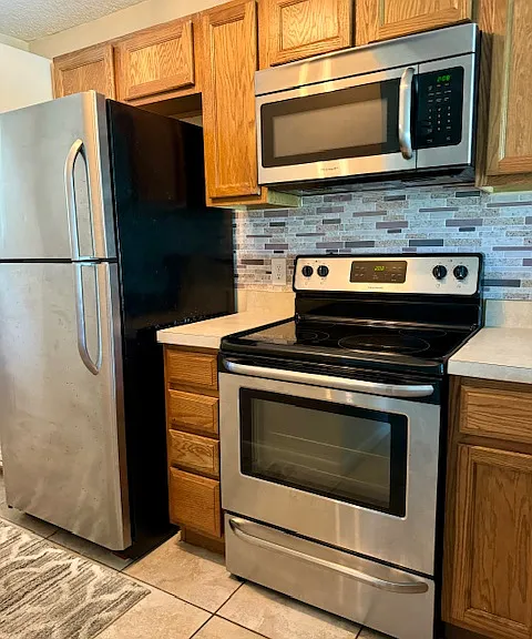 Kitchen with Microwave, Stove and Refrigerator and Dishwasher.
