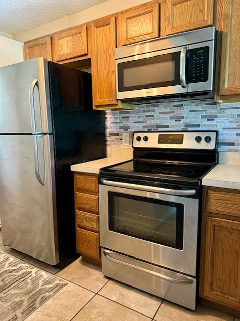 Kitchen with Microwave, Stove and Refrigerator and Dishwasher.