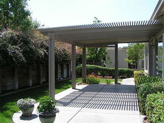 back yard with stamped concrete patio and cover