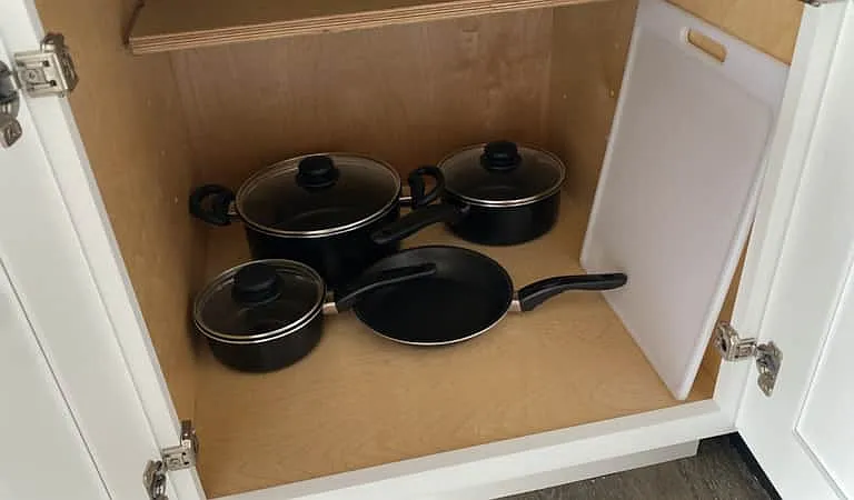 Essential cookware included: pots, lids, and frying pans