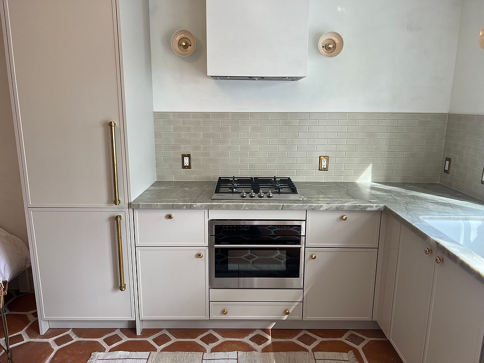 Kitchen with Burner, Convection Microwave, Refrigerator, Sink and Dishwasher. Premium unlaquered brass finishes.