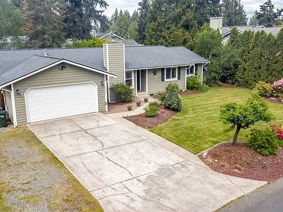 Lots of driveway parking plus two covered RV storages behind the fence.