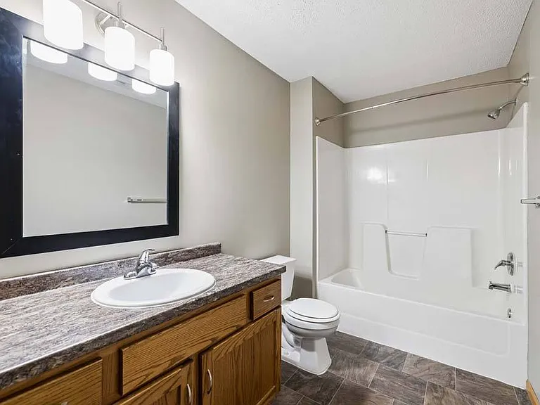 Bright finishes and a spacious vanity pair with a full tub and shower to create a bathroom designed for everyday comfort and convenience.