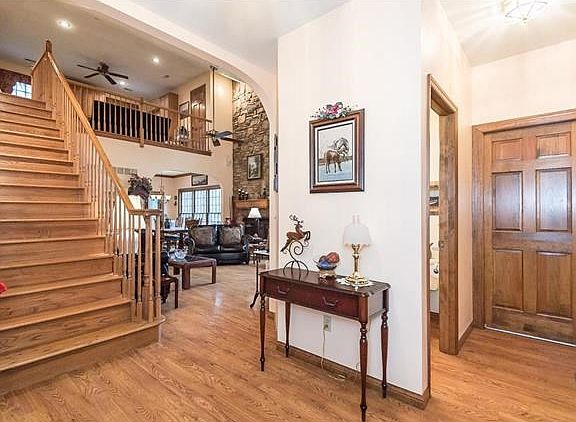 Formal entry.  Spindled stairs and balcony. To the right is the oversized 3 car garage, the main floor laundry room w/ mud sink and half bath.