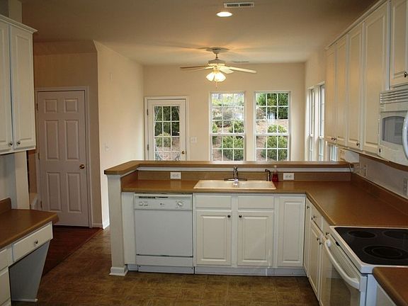 Huge kitchen boasts 42 in. cabinets, smooth surface range, built-in microwave.